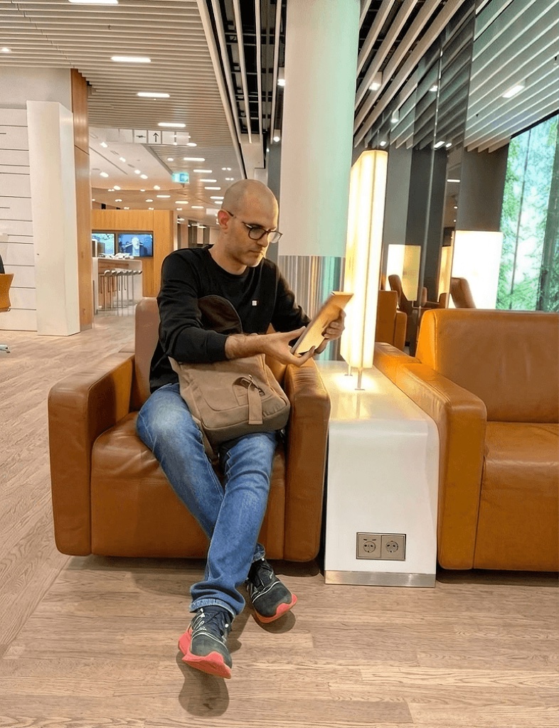 A team member reading on an armchair